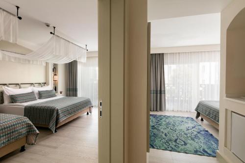 a bedroom with two beds and a window at Limak Cyprus Deluxe Hotel in Iskele