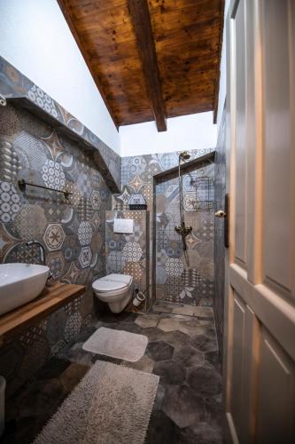a bathroom with a shower and a toilet and a sink at Villa Lav in Bale
