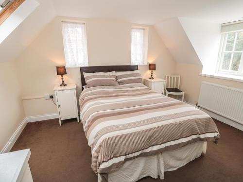 a bedroom with a large bed with two night stands at No 1 Low Hall Cottages in Scalby
