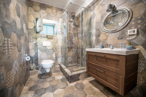 a bathroom with a shower and a sink and a toilet at Villa Lav in Bale