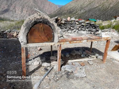 a stone oven with a pile of rocks at Cabañas de Alta Montaña in Ciudad Lujan de Cuyo