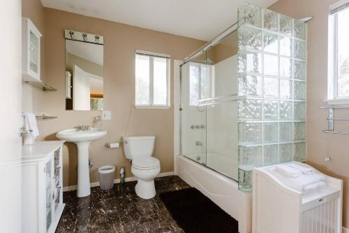 a bathroom with a toilet and a shower and a sink at Sonoma Wine Country Bungalow in Sonoma