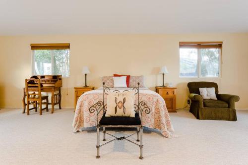 a bedroom with a bed and a chair at Sonoma Wine Country Bungalow in Sonoma