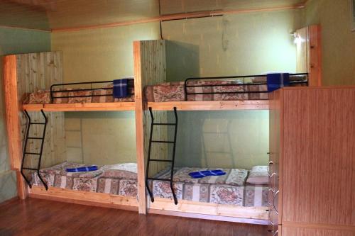two bunk beds are in a room with at Homestay in Kazbegi