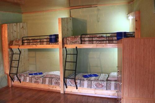 two bunk beds are in a room with at Homestay in Stepantsminda