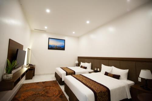 Ένα ή περισσότερα κρεβάτια σε δωμάτιο στο Nhat Quang Hotel
