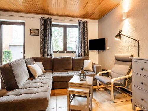 a living room with a couch and a tv at Gite in Lessive close to Rochefort in Rochefort