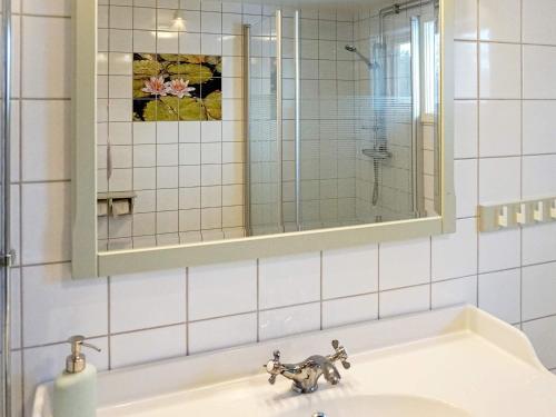 a bathroom sink with a mirror and a sink at Holiday home ÅSBRO II in Åsbro