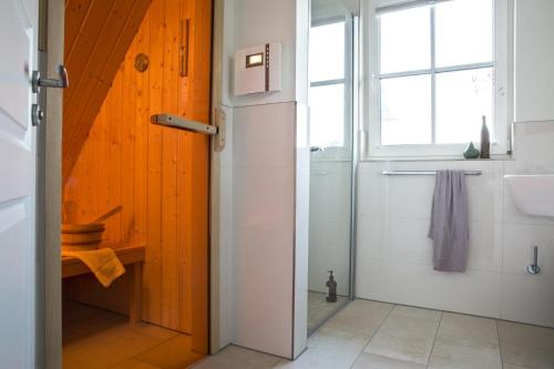 a bathroom with a shower and a sink at Ferienhaus Schilfrohrsaenger 8 in Fuhlendorf