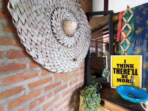 a wreath hanging on a brick wall with a sign at La happycleta in Palomino