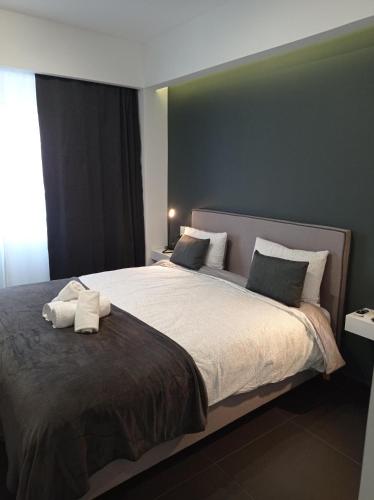 a bedroom with a large bed with two towels on it at NY Central 1 in Patra