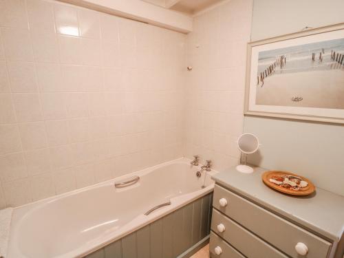 a bathroom with a bath tub and a sink at Jane's Place in Launceston
