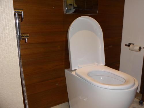 a bathroom with a toilet with the lid up at The Promenade in Puducherry