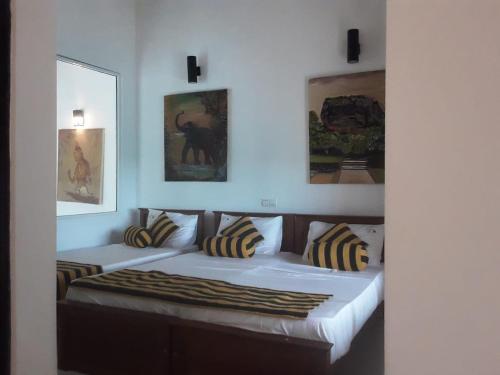 ein Schlafzimmer mit 2 Betten mit Kissen darauf in der Unterkunft Elephant safari Lodge sigiriya junction in Habarana