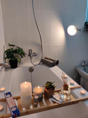 a bathroom with a bath tub with candles and plants at Luxury Apartment with pool view in Adeje