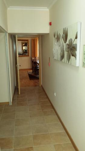 a hallway with a tile floor and a painting on the wall at Cantinho da Estrela in Seia