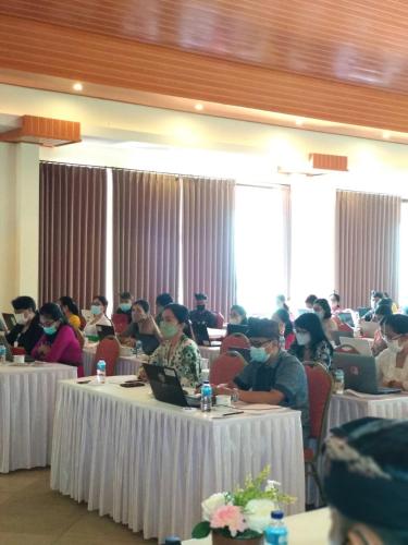 a group of people sitting at tables with their laptops at Kori Maharani Villas & Resort in Keramas