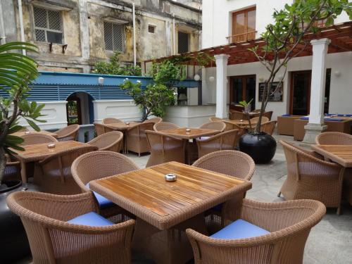 an outdoor seating area with tables and chairs at The Promenade in Puducherry