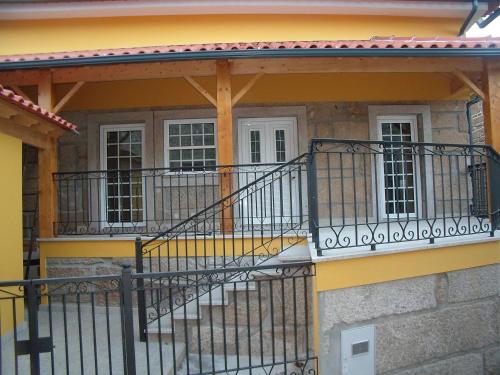 a house with a yellow and black balcony at Cantinho da Estrela in Seia