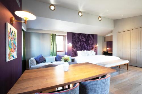 a hotel room with a bed and a table at PETALS TOKYO - Floating Hotel in Tokyo