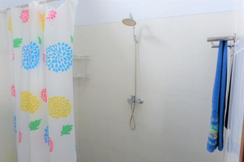 a bathroom with a shower with a shower curtain at Karauci Homestay in Abeansemal