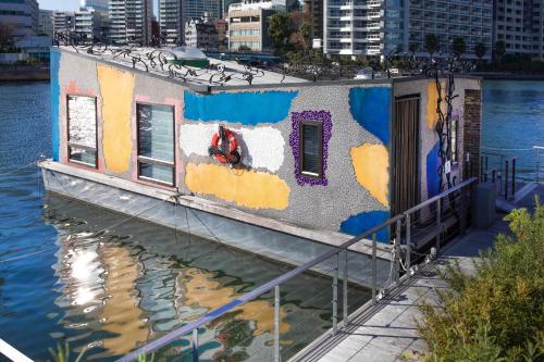 a painting of a house on a boat in the water at PETALS TOKYO - Floating Hotel in Tokyo