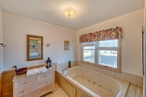 a bathroom with a large tub and a window at Dolphin Watch Avon 413 in Avon