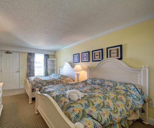 a bedroom with two beds and a window at Bodie's Anchor 141 in Hatteras