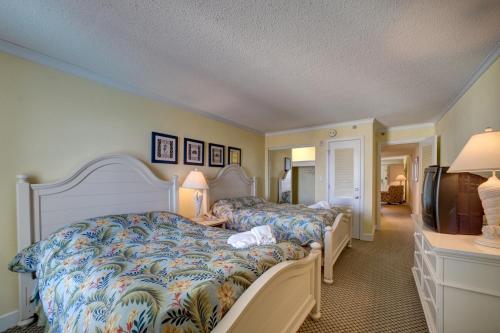 a hotel room with two beds and a television at Bodie's Anchor 141 in Hatteras