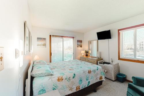 a bedroom with a bed and a television in it at Oceanside Fun 952 RR in Rodanthe