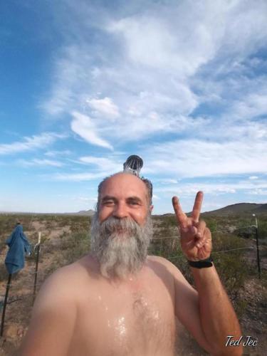a man in a bathtub giving the peace sign at Camping at Desert Gardens Oasis in Lobo, TX in Van Horn