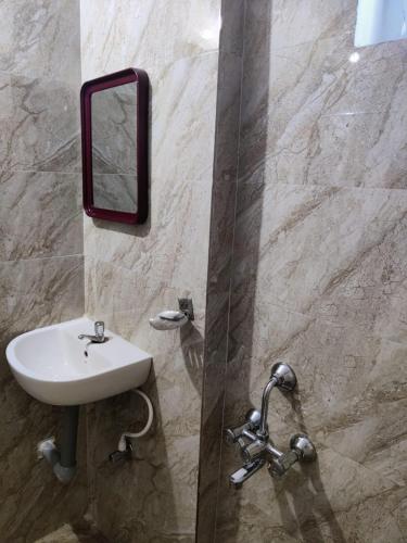 a bathroom with a sink and a mirror on the wall at Hotel Destiny in Visakhapatnam