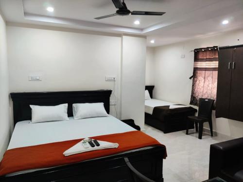 a bedroom with a bed and a chair in it at Hotel Destiny in Visakhapatnam