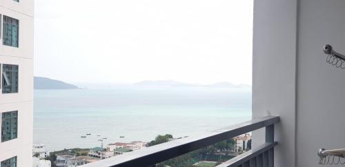 a view of the ocean from the balcony of a building at Stay in Nha Trang Apartment in Nha Trang