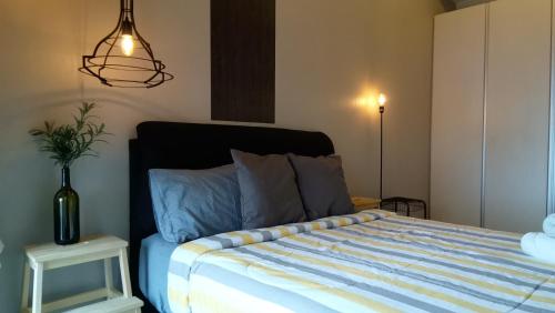 a bedroom with a bed with a blue comforter and a lamp at MCity Jalan Ampang KLCC in Kuala Lumpur