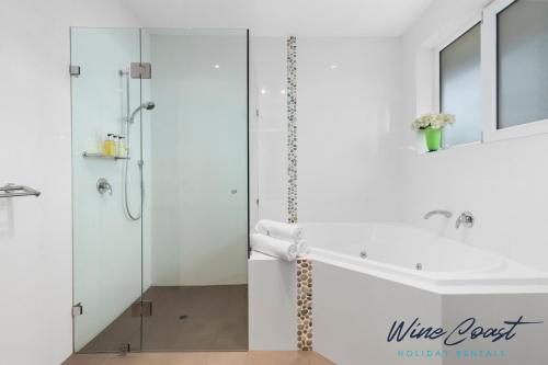 a bathroom with a glass shower and a sink at 35 Degrees South by Wine Coast Holiday Rentals - Escape to the fabulous 35 Degrees South by Wine Coast Holiday Rentals. in Port Noarlunga