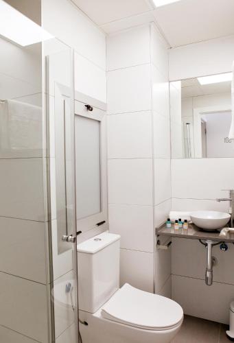 a white bathroom with a toilet and a sink at San Remo in Alicante
