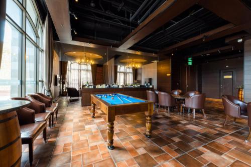 a room with a pool table and chairs at Grand Cosmos Resort Ruisui Hualien in Ruisui