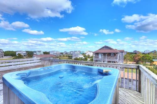 a hot tub on the balcony of a house at Tinker's Toy 233 in Waves