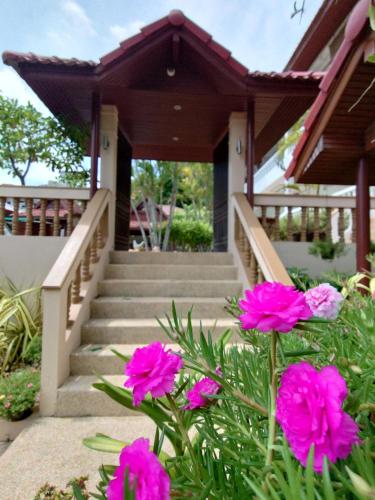 a house with pink flowers in front of it at Samui Little Garden Resort in Chaweng