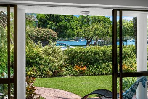 a sliding glass door looking out at a yard at The Noosa Apartments in Noosa Heads