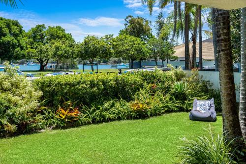 a garden with a pillow sitting on the grass at The Noosa Apartments in Noosa Heads