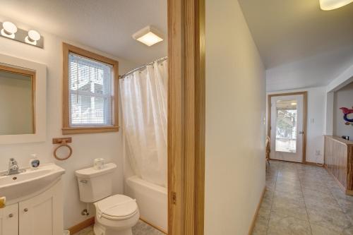 a bathroom with a toilet and a sink at Whale Inn 208 in Avon