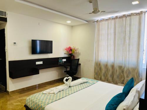 a hotel room with a bed with a towel on it at Hotel Elite By Signature Group in Hyderabad