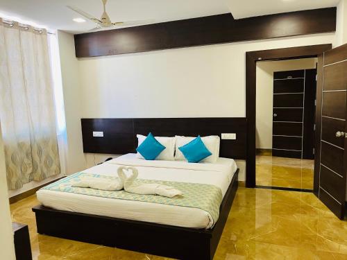 a bedroom with a bed with two swans on it at Hotel Elite By Signature Group in Hyderabad