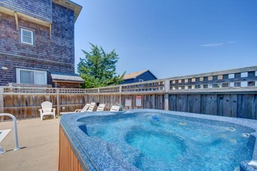 a large hot tub on a deck with a house at Passing Winds 741 in Salvo
