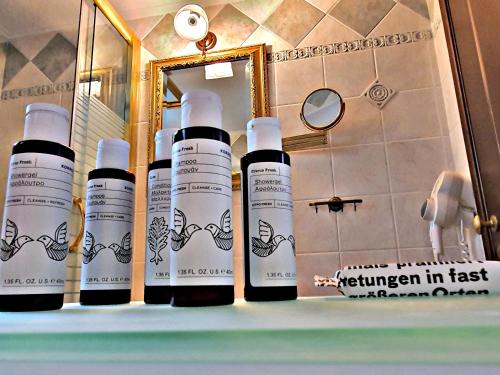 a group of four bottles of hair products on a bathroom counter at Acroploro in Galaxidi