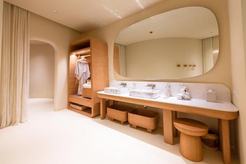 a bathroom with two sinks and a large mirror at Sala Khaoyai in Wangkata
