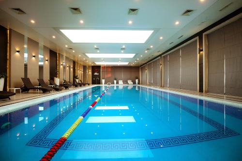 a large swimming pool in a hotel room at WELLNESS HOTEL and SPA in Tashkent