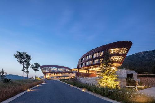 a building with a long road in front of it at Runaway Cow Winery Retreat in Yantai